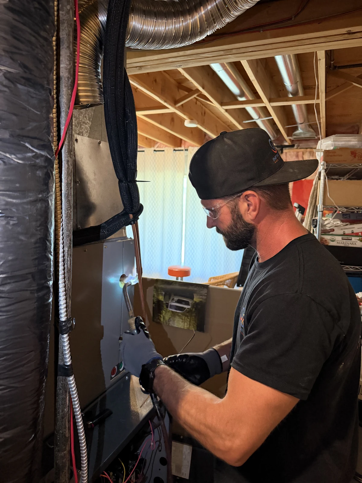 Infinite Heating technician working on residential furnace equipment