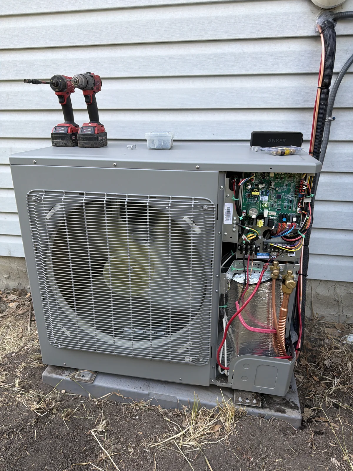 Outdoor air conditioner opened for electrical diagnosis and repair